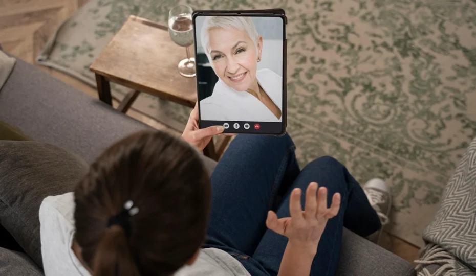 lady is talking with someone on her tablet for online occupational therapy